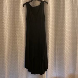 Black cocktail dress. Zips on the side. Short in front and flares in the back.